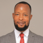 Abraham Luzzi speaking on government reforms in Kampala